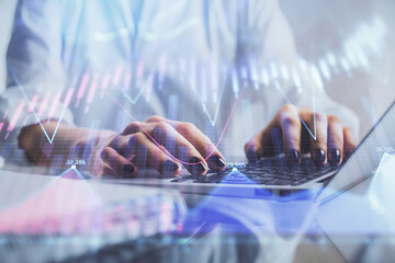 Double exposure of woman hands typing on computer and forex chart hologram drawing. Stock market invest concept.