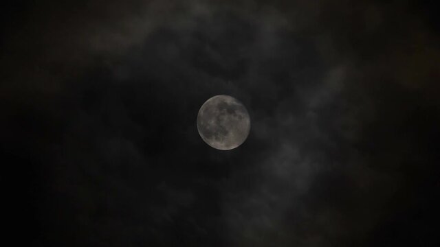 Full moon in the sky with clouds at night.