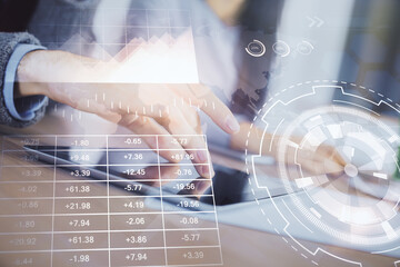 Double exposure of forex graph drawing and man and woman working together holding and using a mobile device. Trade concept.