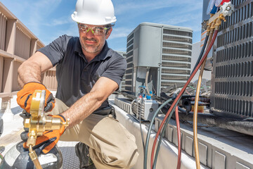 HVAC technician wearing PPE repairing a air conditioner 