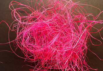 pink threads on a brown background.abstraction.