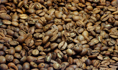 Dark roasted coffee beans background, top view