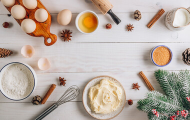 Christmas Baking background with eggs, flour, sugar, milk and butter on a white wooden background. Delicious and healthy food. Flat lay.