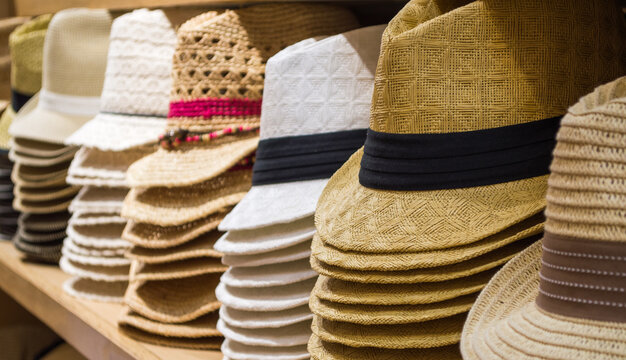 shelves full of  straw sun hats and Panama hats for sale in a shop