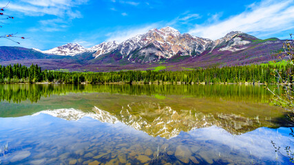 Reflection of Pyramid Mountain in Pyramid Lake in Jasper National Park in Alberta, Canada. The mountains is part of the Victoria Cross Range in the Rocky Mountains