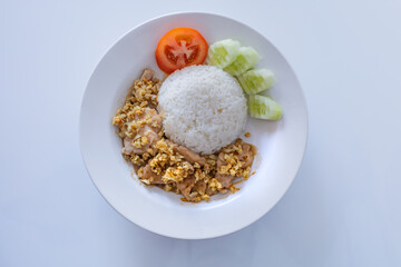 Fried Pork with Garlic Pepper on Rice, sidedish with sliced tomatoes and cucumber