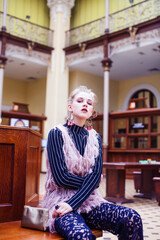 young pretty blond girl posing in fashion style at vintage europe hall interior, lifestyle rich people concept