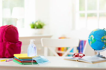 Backpack of school child. Face mask and sanitizer.