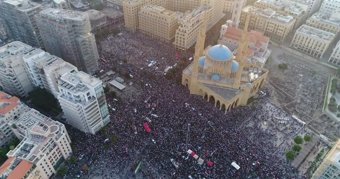 Beirut, Lebanon 2019 : day drone shot of Martyr square, during the Lebanese revolution, with thousands of protesters revolting against government failure and corruption, ending with church and mosque 