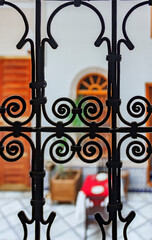 Intricate forged metal work on a banister inside a typical Moroccan riad  in Fes, Morocco