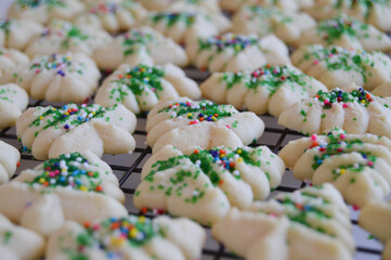 Festive spritz cookies on a cooling rack