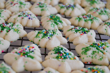 Festive spritz cookies on a cooling rack