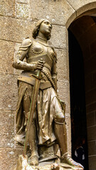 Obraz premium Knight armour on the territory of Le Mont Saint-Michel, an island commune in Normandy, France. UNESCO World Heritage