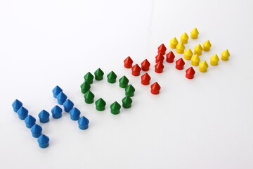 The word Home made from small game pieces of little huts