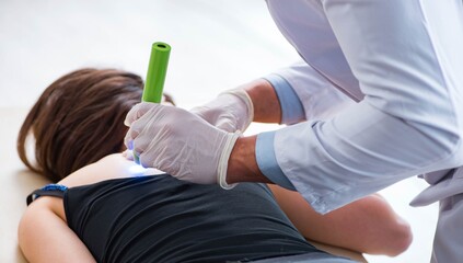 Patient in clinic undergoing laser scar removal