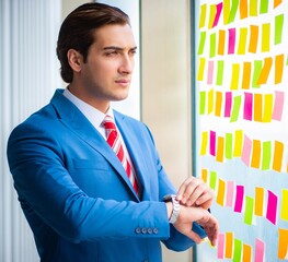Young handsome employee with many conflicting priorities