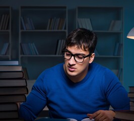 Student preparing for exams late at night in library