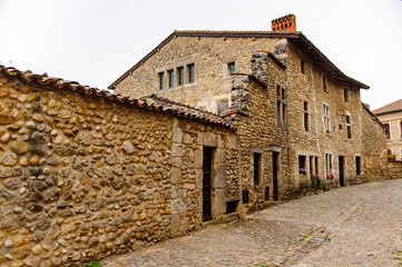 Fototapeta na wymiar Narrow street in Perouges, France, a medieval walled town, a popular touristic attraction.