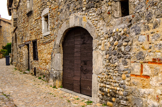 Narrow street in  Perouges, France, a medieval walled town, a popular touristic attraction.
