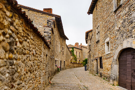 Narrow street in  Perouges, France, a medieval walled town, a popular touristic attraction.