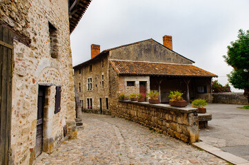 Fototapeta na wymiar Street of Perouges, France, a medieval walled town, a popular touristic attraction.
