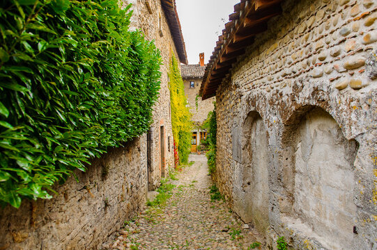 Narrow street in  Perouges, France, a medieval walled town, a popular touristic attraction.