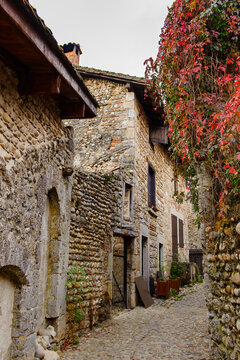Narrow street in  Perouges, France, a medieval walled town, a popular touristic attraction.