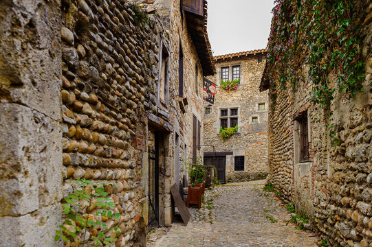 Narrow street in  Perouges, France, a medieval walled town, a popular touristic attraction.
