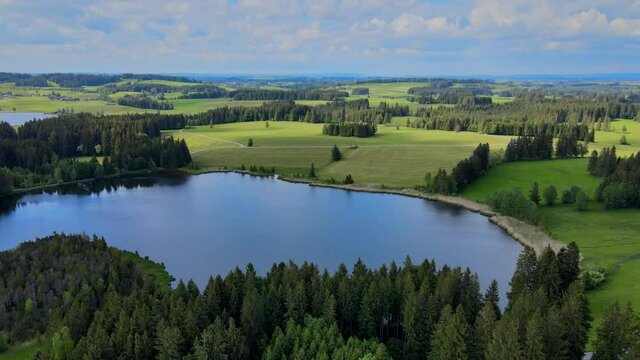 Flight over the beautiful rural landscape of Bavaria Allgau in the German Alps. Aerial view