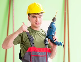 Young man carpenter working in workshop