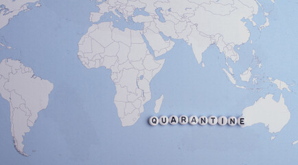 The word Quarantine on an easel,isolated over a world map