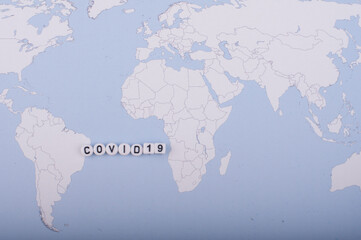 The word covid 19 over world map