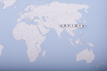 Fototapeta na wymiar The word covid 19 over world map,high angle shot