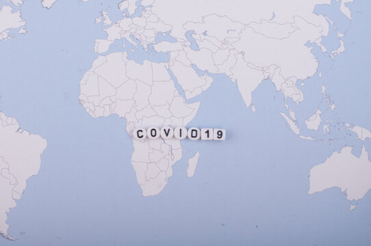 The Word Covid 19 Over World Map,high Angle Shot