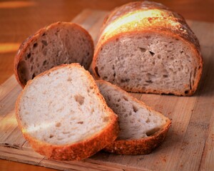 Homemade artisan sourdough rye bread on wood board.