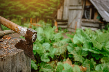 Old wooden building for shepherd with axe in Carpathian mountains