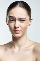 Headshot of emotional female face portrait with wink.