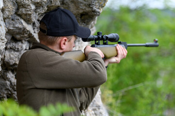 Male with a gun in hunting period