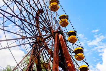 Observation wheel carousel with yellow cabins in the former musement park in Pripyat, a ghost town...