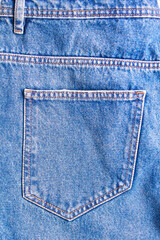 jeans pocket texture closeup. blue denim with yellow stitching.
