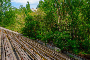 Fototapeta premium Trees grown just on the former sport stadium in Pripyat, a ghost town in northern Ukraine, evacuated the day after the Chernobyl disaster on April 26, 1986