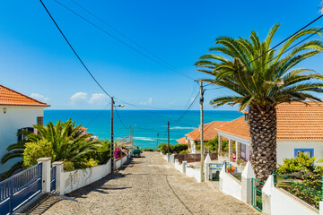 Obraz premium Picturesque streets and view over the ocean in the tiny Portuguese ocean village Ericeira, Portugal. Travel to the sea.