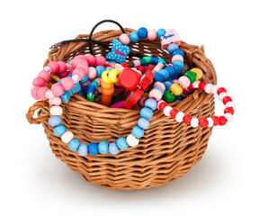 Small basket with children's beads. Childish bijouterie in small wicker basket. Isolated on white...