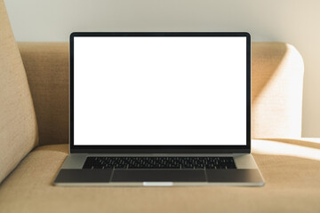 Fototapeta premium Mock up Blank screen laptop on the sofa for advertising and text.