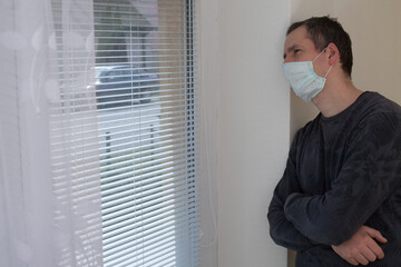 Quarantine theme. Stay home because of the virus outside. Korona virus theme. The man with the...