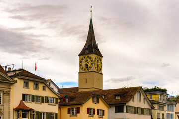 Fototapeta na wymiar Clock tower over the buildings in Zurich, Switzerland
