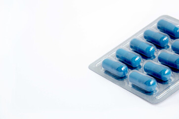 Blister of blue capsules on a white background
