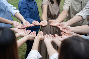 Group of Asian people raise up their right hands and handle gently to obtain and sharing good feeling to gether in Training Teambuilding.