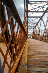 old bridge in rusty metal structure and wooden floor of Saint-Pie, Quebec