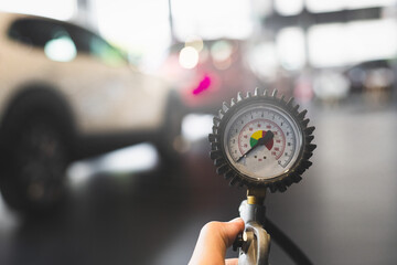 inspection Measure quantity Inflated Rubber tires car Close up hand holding machine Inflated pressure gauge for car tyre pressure measurement for automotive automobile